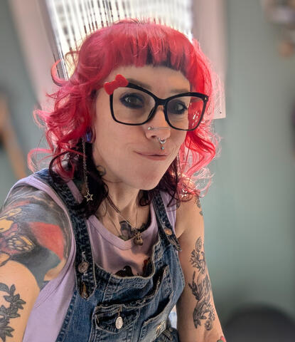 "Headshot of Autumn Pinnix, LMBT, a therapeutic massage therapist in Winston-Salem with bright pink hair and visible tattoos."